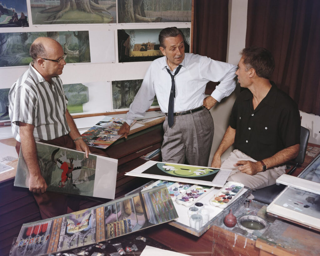 18. Layout artist MccLaren Stewart Walt Disney and Eyvind Earle at the Disney Studio during production for Sleeping Beauty c. 1959 courtesy of Eyvind Earle Publishing LLC c Disney 1
